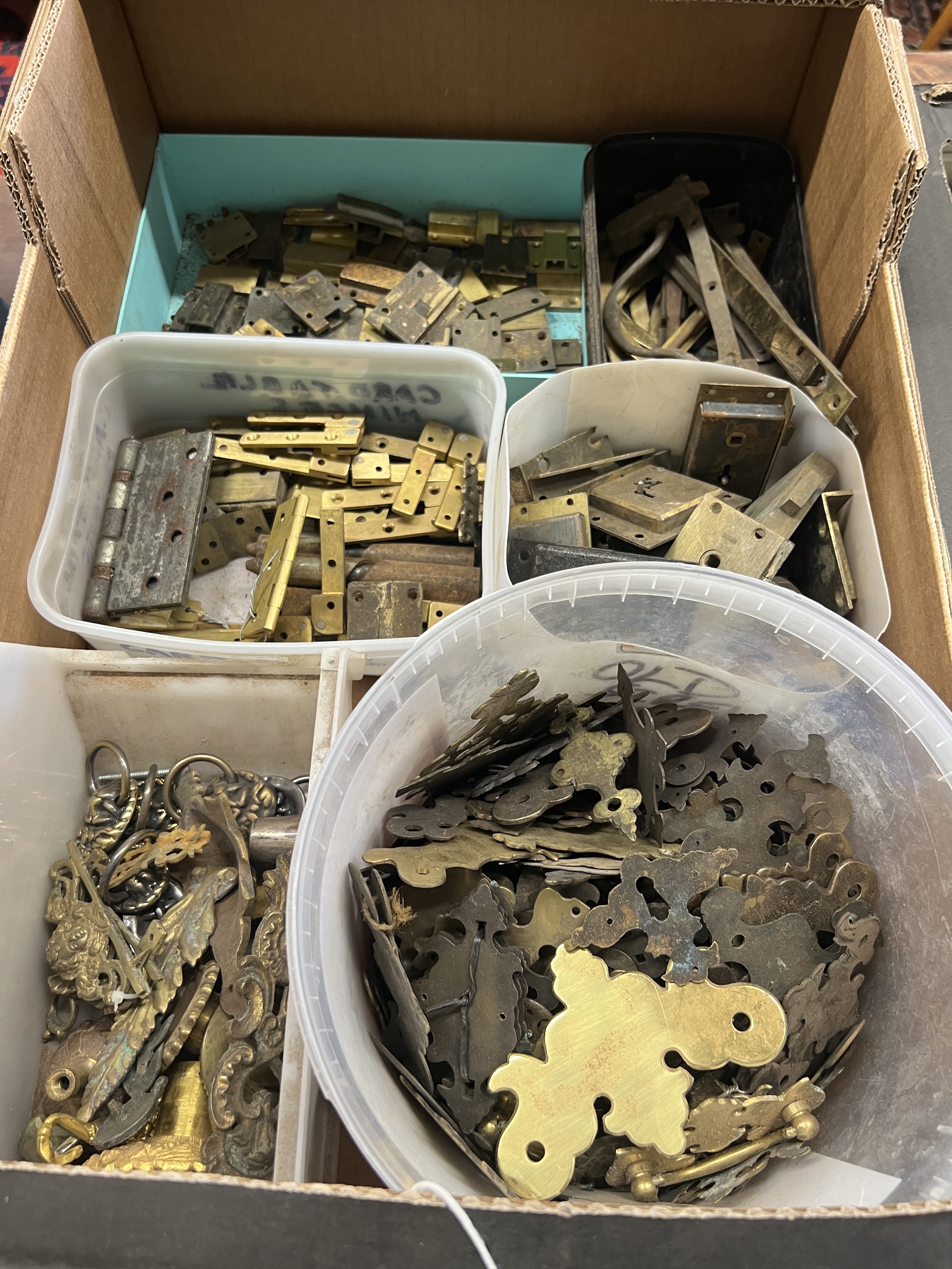 A quantity of assorted brass furniture mounts, escutcheons, locks, hinges, etc.